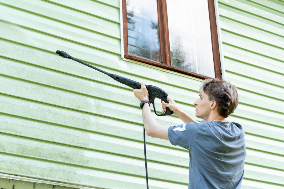 The Importance of Power Washing and Prepping - Arch Painting -Commercial Painter | Residential Painter Power washing the siding of an exterior.