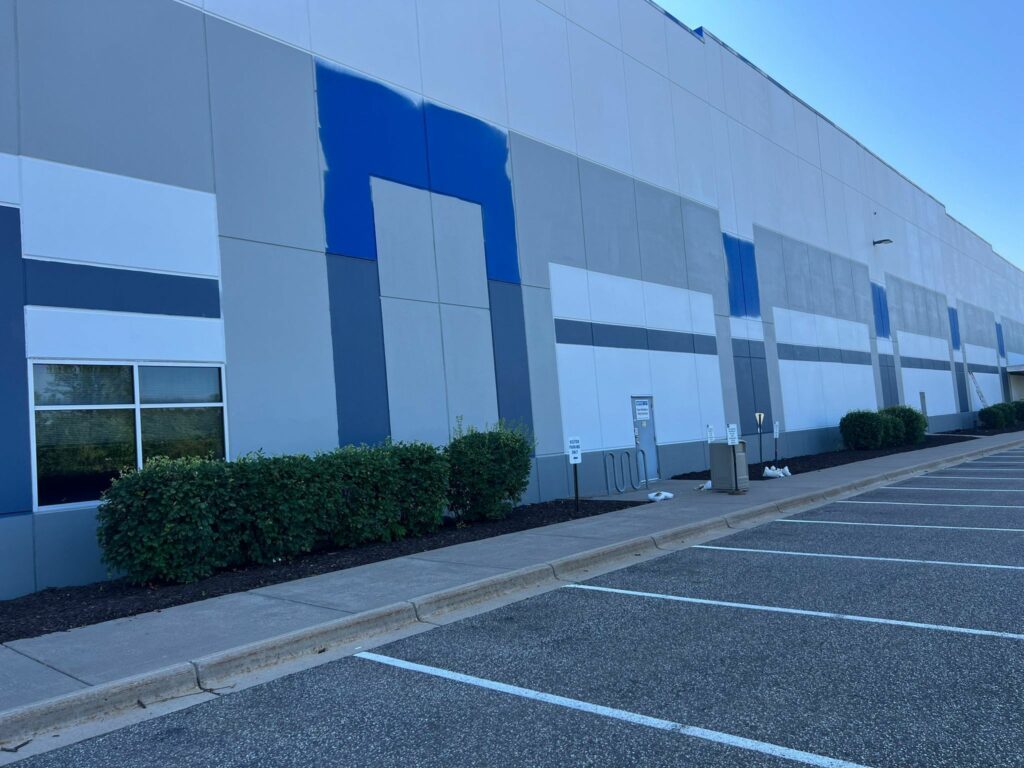 In progress view of exterior painting a commercial building