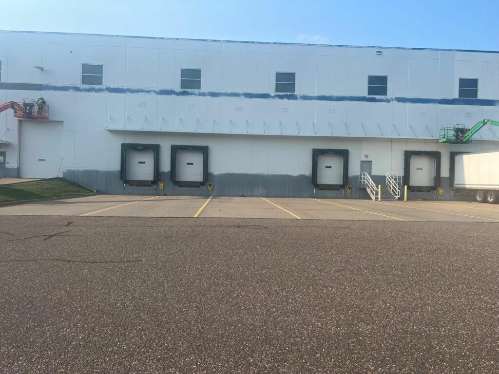 In progress view of exterior painting a commercial building
