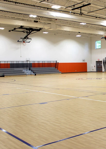 gymnasium A gymnasium with a basketball court and a basketball hoop.