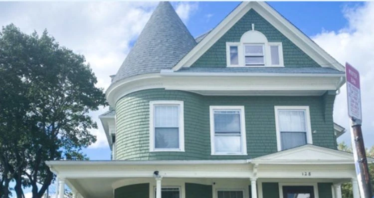 ArchVT2 A green house with a turret on top, brought to life by the skilled hands of Vermont Commercial & Residential Painters from Arch Painting.